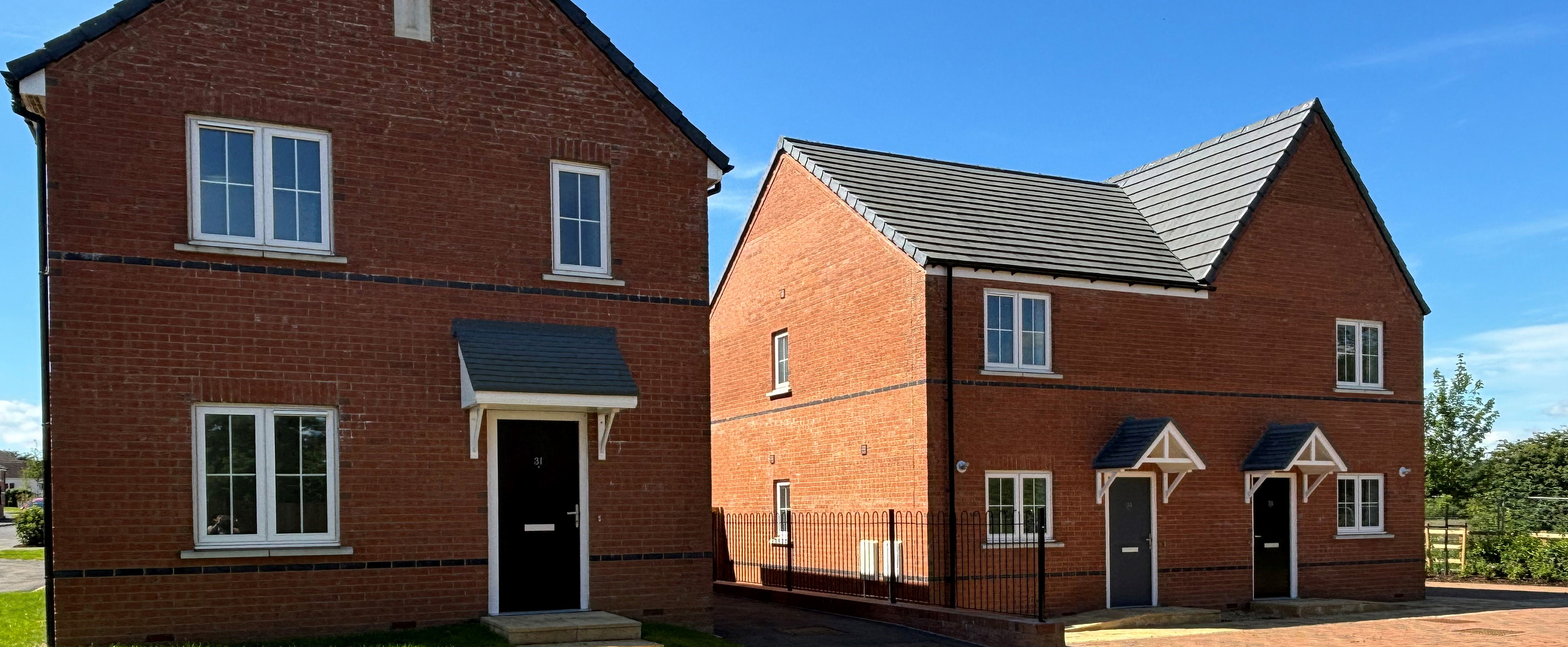 Photo of three new build houses