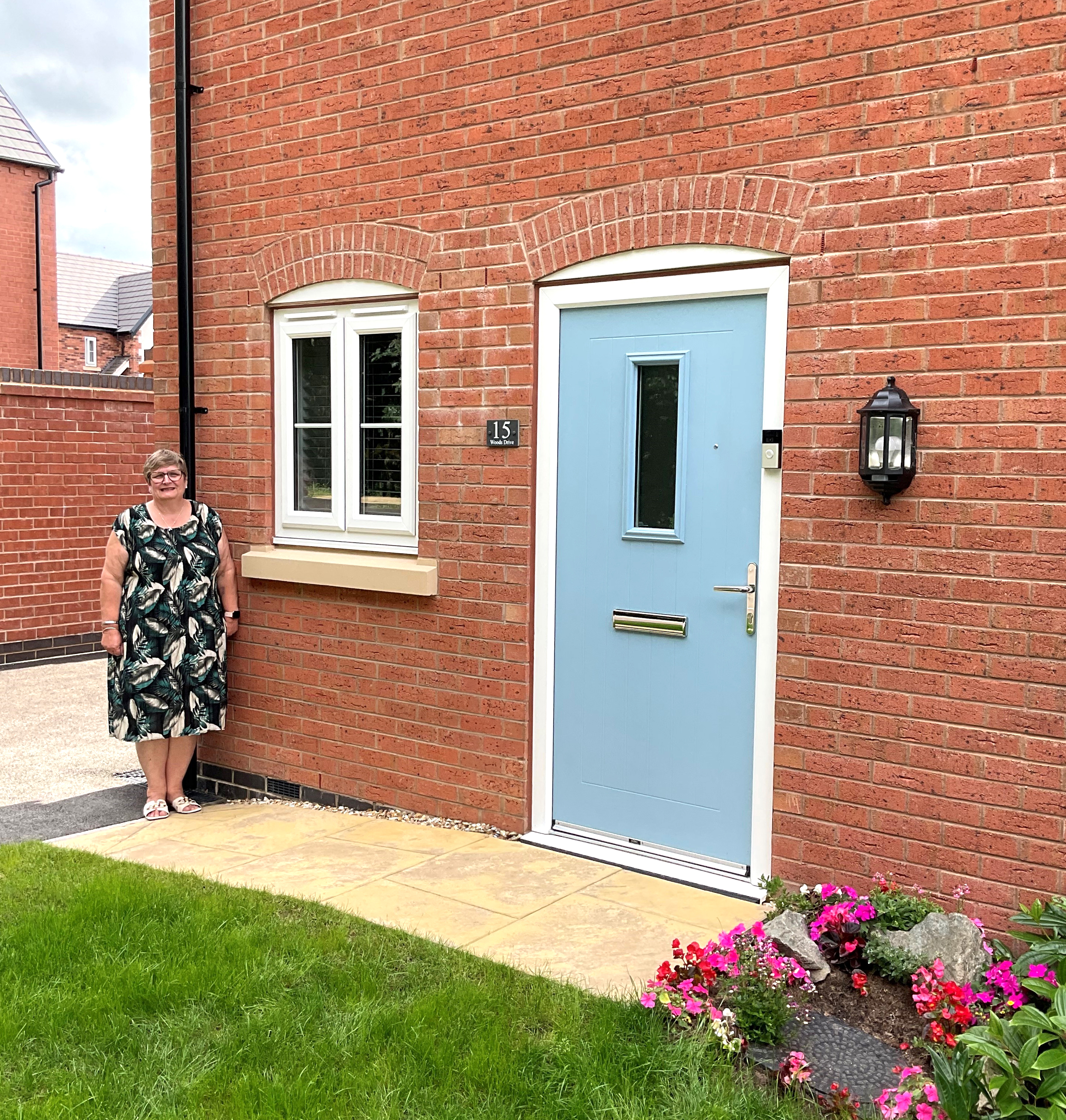 Photo of Futures customer Liz standing in front of her new home