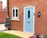 Photo of Futures customer Liz standing in front of her new home