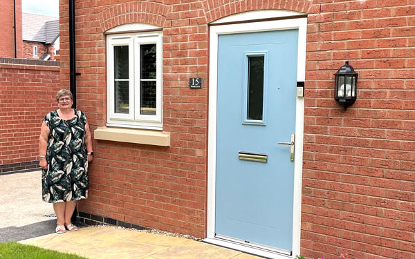 Photo of Futures customer Liz standing in front of her new home