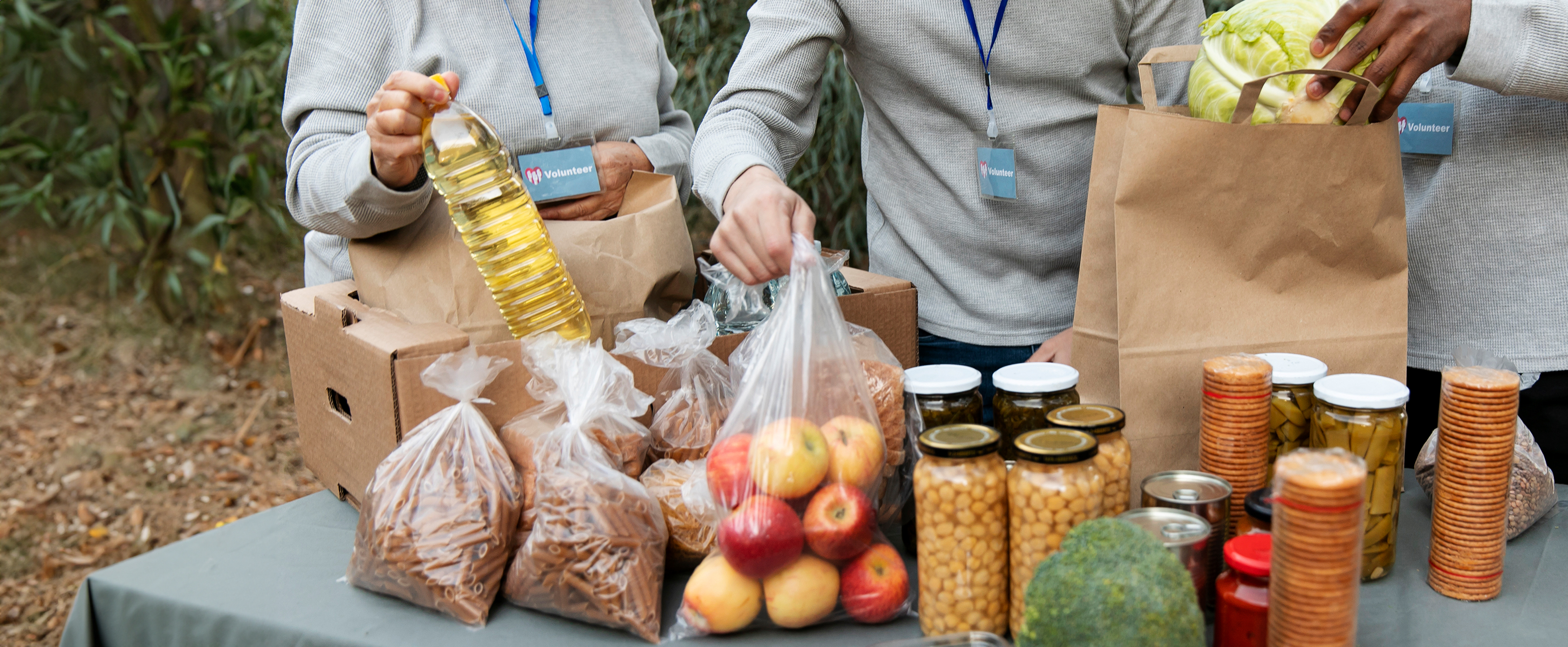close up photo of volunteers arranging various types of food and ingredients on a table