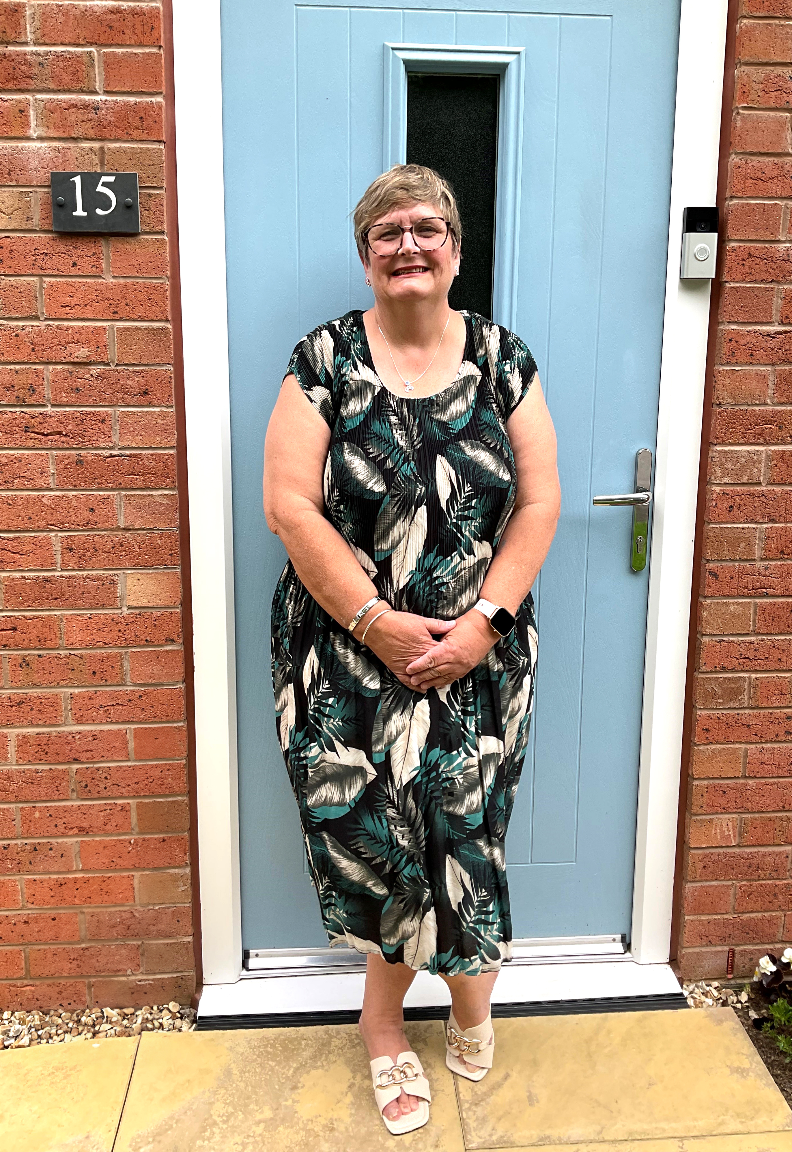 Photo of Futures customer Liz standing in front of  her new front door