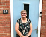 Photo of Futures customer Liz standing in front of  her new front door