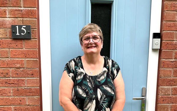 Photo of Futures customer Liz standing in front of  her new front door