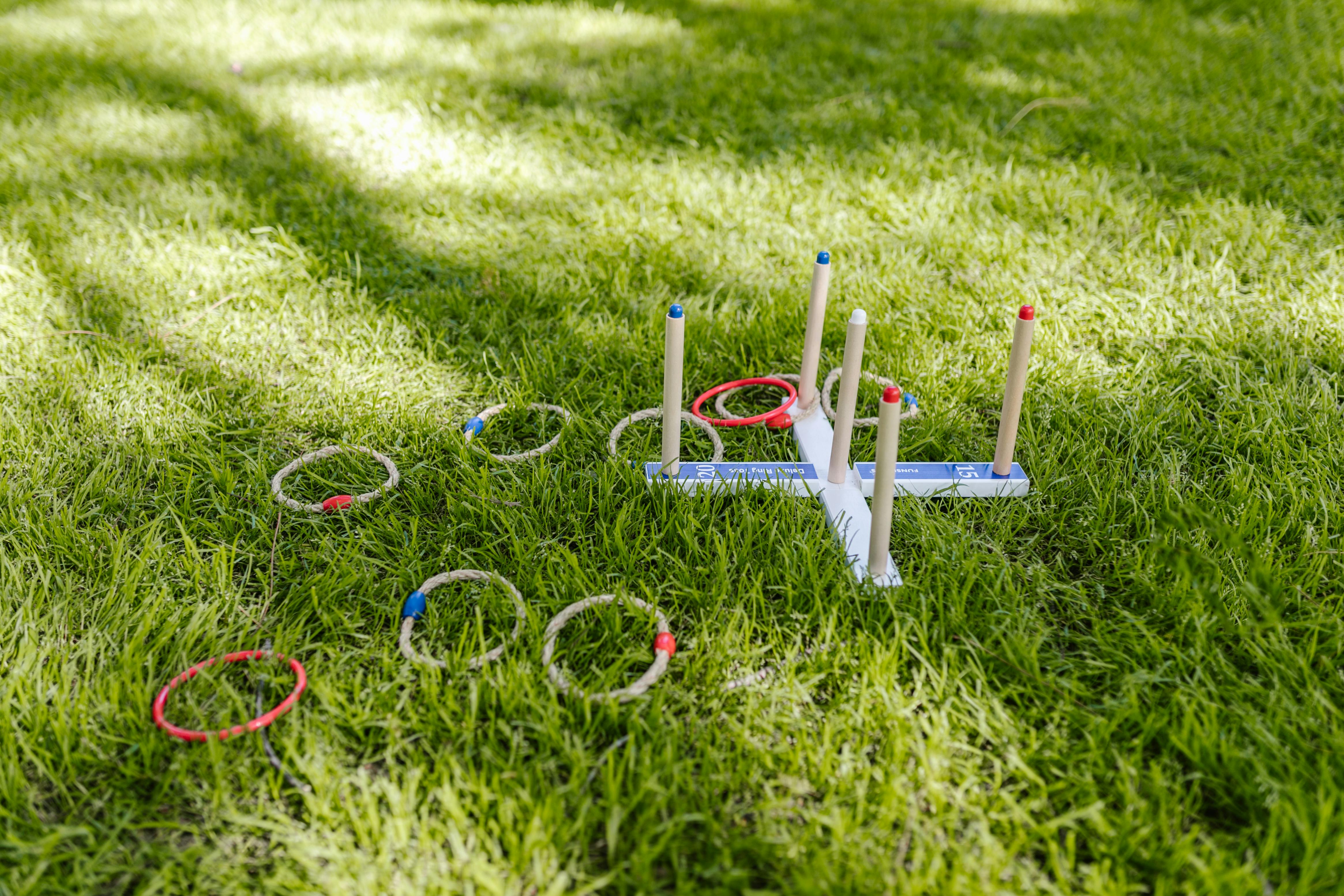 Photo of a 'throw the ring over the peg' children's game lying on grass