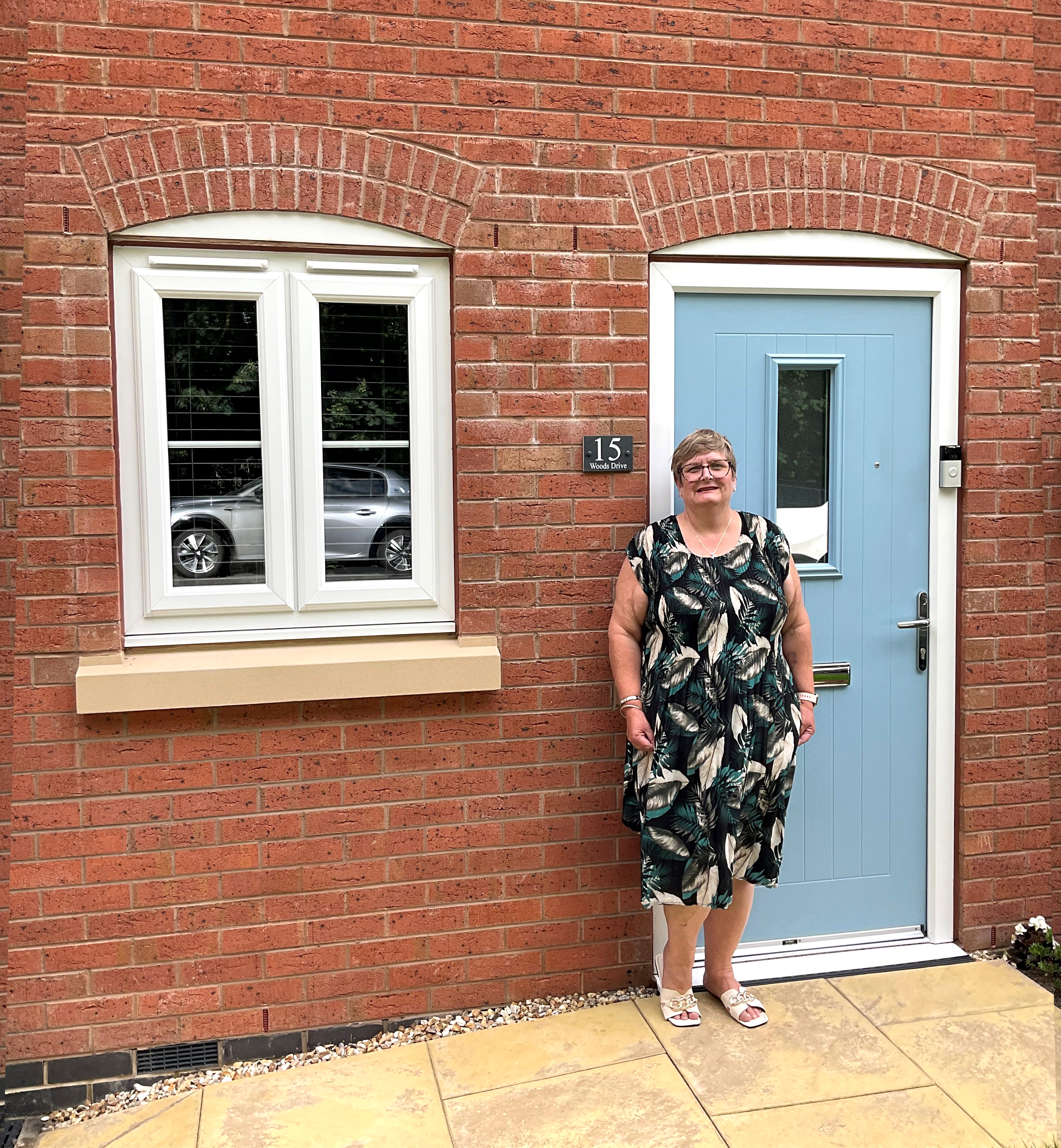 Photo of Futures customer Liz standing in front of her new home