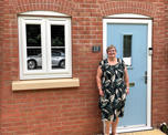 Photo of Futures customer Liz standing in front of her new home