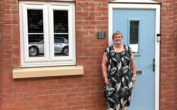 Photo of Futures customer Liz standing in front of her new home