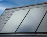 Close up  photo of solar panels on the pitched roof of a new housing development