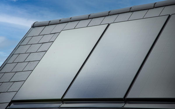 Close up  photo of solar panels on the pitched roof of a new housing development